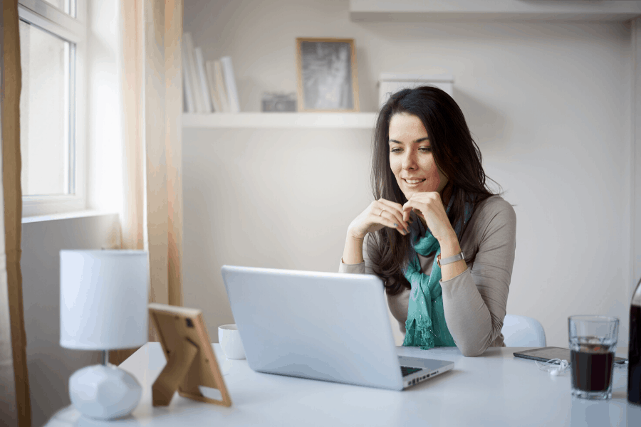 woman looking at a laptop and working from home