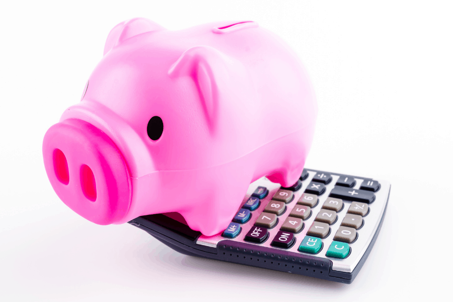 piggy bank sitting on top of a calculator